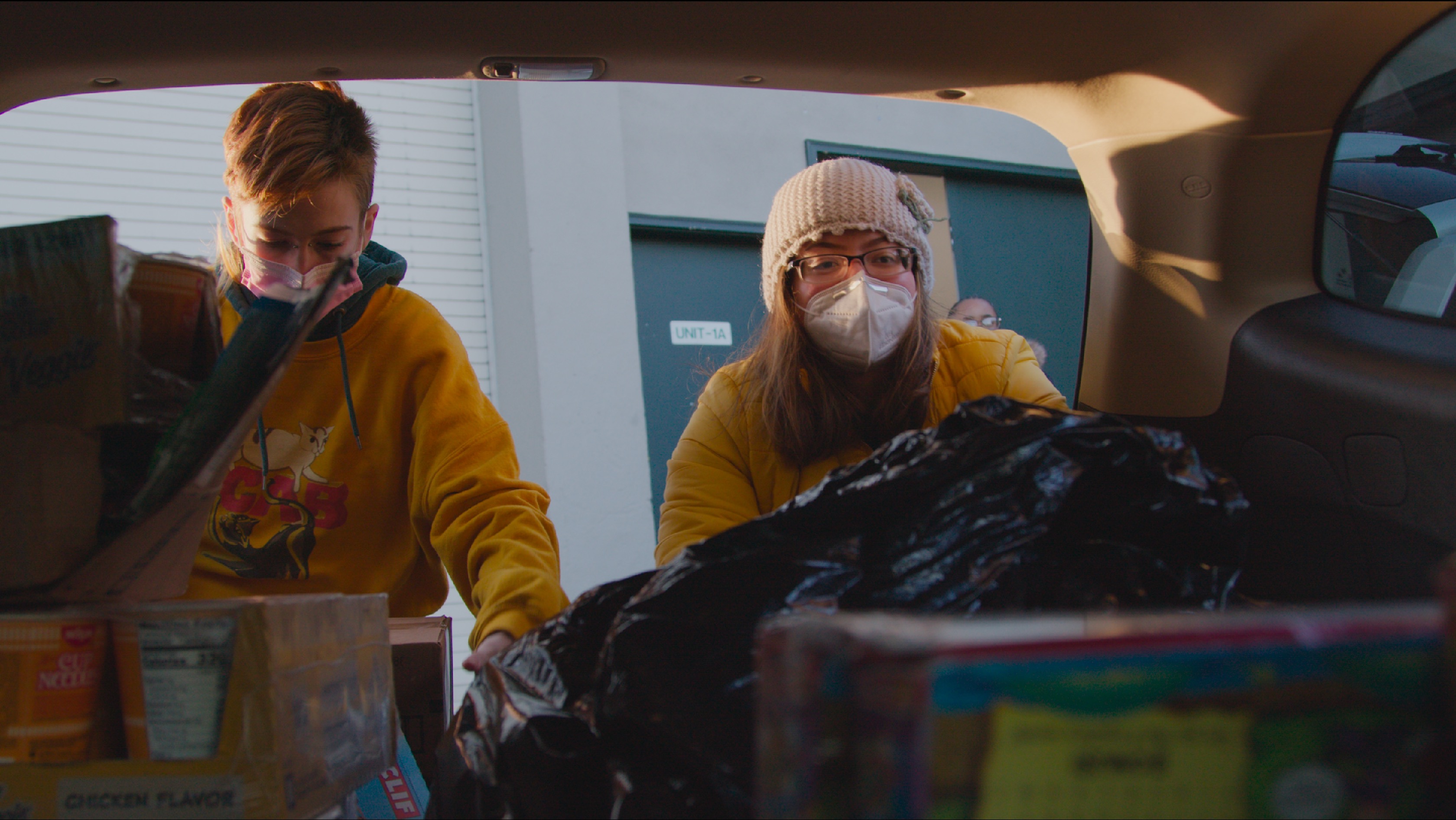 Leo and Genesis distributing food.