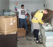 two people salvaging computers