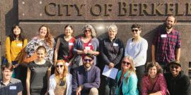 Group of 14 berkeley worker co-op advocates outside city council chambers.