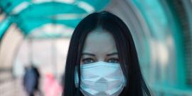 Woman wearing a surgical mask.