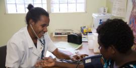 Doctor performs blood pressure check on a patient.