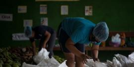 Women organize supplies for food swap.