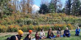 Mumbet's Freedom Farm group sitting in a circle on the grass.