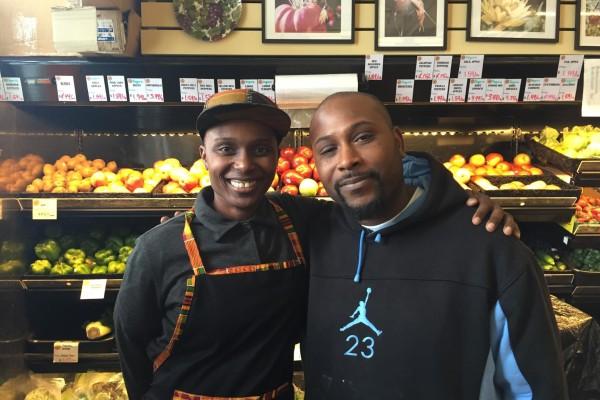 Adrionna Fike and James Bell, two of the worker-owners at Mandela Foods, in front of their revamped produce cooler.