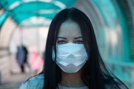Woman wearing a surgical mask.