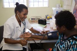 Doctor performs blood pressure check on a patient.