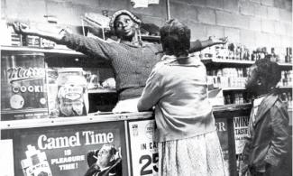 Woman standing behind the counter of a cooperative market.