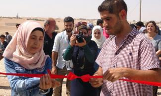 Inaugaral celebration of cooperative generator project in Manbij. Image via <a href="https://cooperativeeconomy.info/mualda-cooperative-to-provide-electricity-to-200-houses-in-village-of-manbij/" target="_blank">Co-operative Economy in Rojava & Bajkur</a>.